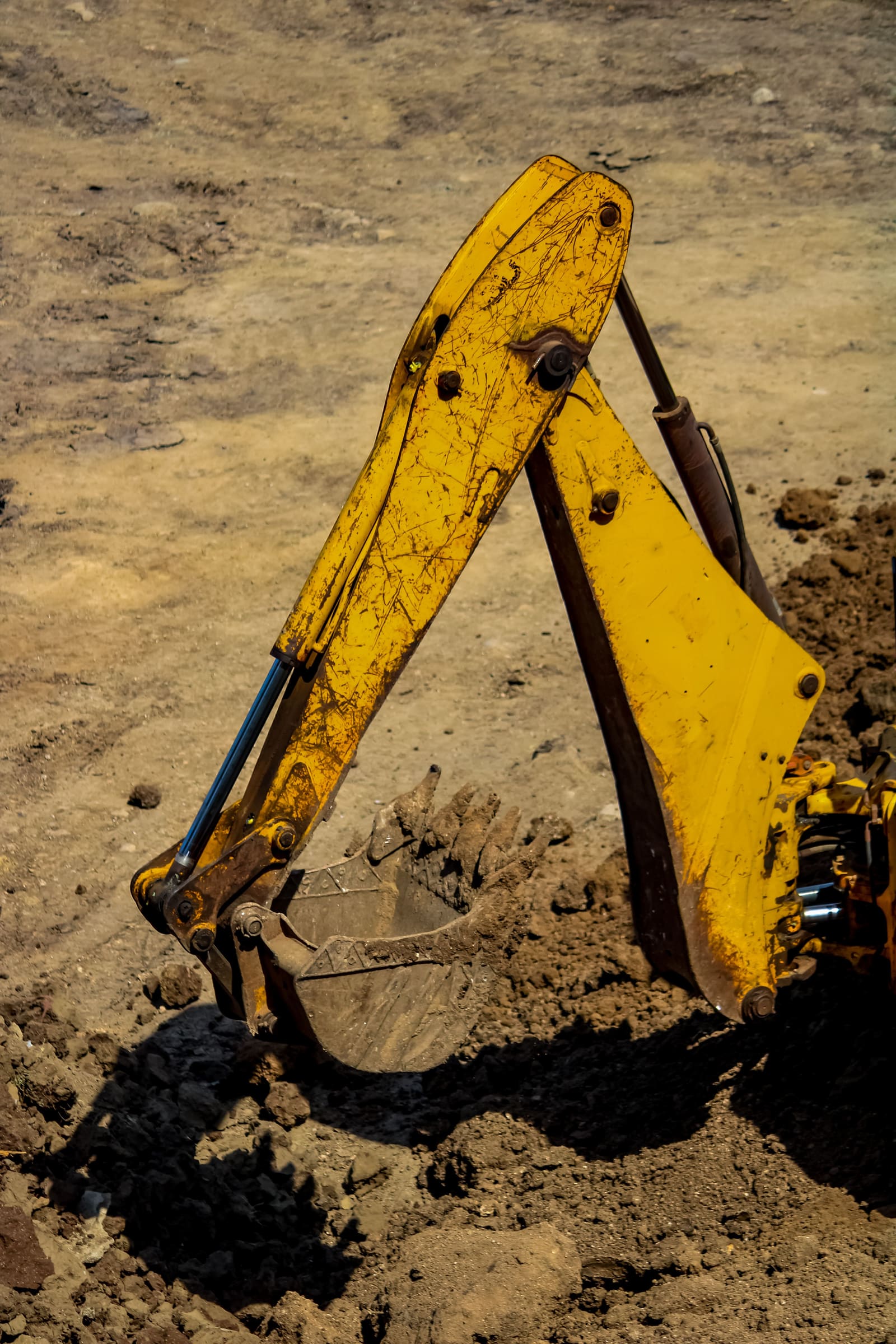 Close-up of an excavator bucket digging into the ground